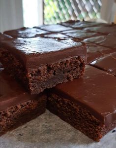 three pieces of chocolate cake stacked on top of each other