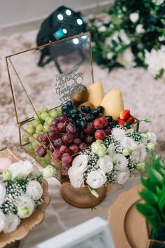 a table with flowers and fruit on it