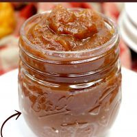 a jar filled with peanut butter sitting on top of a white plate