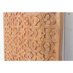 an intricately carved wooden panel on the side of a building