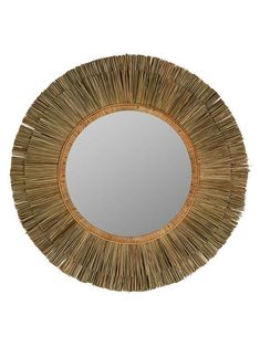 a round mirror that is made out of straw