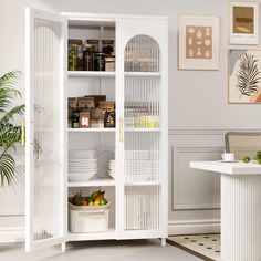 a white bookcase filled with lots of books next to a dining room table