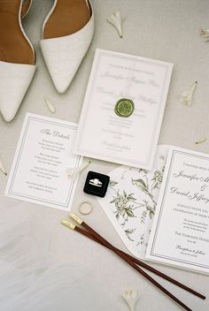 the wedding stationery is laid out and ready to be put into the bride's shoes