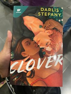 the cover to cloverr, with an image of two women hugging each other and one man