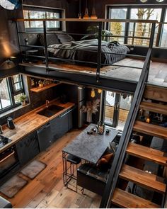 a loft with stairs leading up to the bedroom and living room, as seen from above