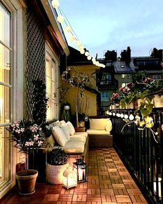 an outdoor patio with lights and potted plants