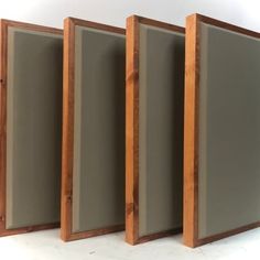 three wooden frames are lined up against the wall