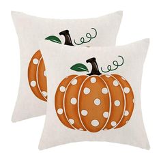 two decorative pillows with pumpkins on them