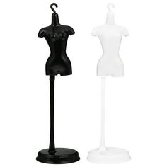 two mannequins standing next to each other on a white and black stand