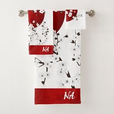 two towels hanging on a towel rack with monogrammed flowers and the letter nf