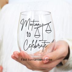 a person holding a wine glass with the words motions to celebrate written in black ink