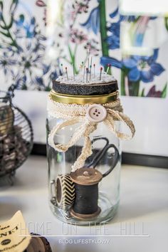 a glass jar with some pins in it