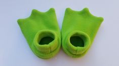 pair of green slippers on white surface