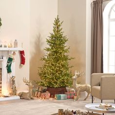 a living room filled with furniture and a christmas tree