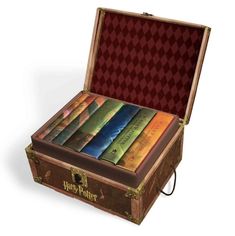 an open harry potter book case with seven books in it and the lid opened on top