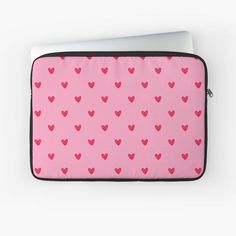 a pink laptop case with red hearts on it