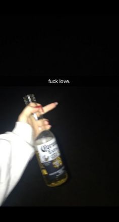 a person holding a bottle in their hand with the caption tuck love on it