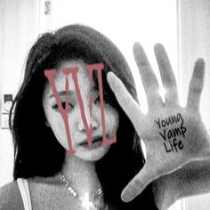 a woman holding up her hand with the words young vampire life written on it