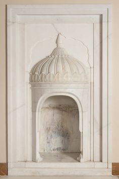 a white marble fireplace surround in a room