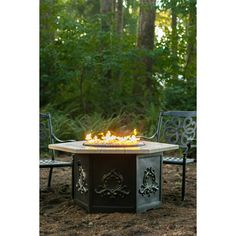 an outdoor fire pit with chairs around it