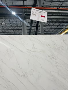 a large white marble slab in a warehouse with a sign on it that says,