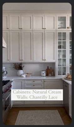 a kitchen with white cabinets and an area rug