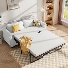 a white couch sitting on top of a wooden floor