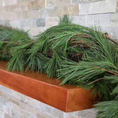 some pine branches are sitting on a shelf