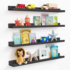 two black floating shelves with books and toys on them, one is holding a stuffed animal