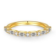 a yellow gold wedding band with baguettes and diamonds on the sides, set against a white background