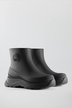 Sporty Waterproof High-top Rain Boots, Sporty High-top Waterproof Rain Boots, Waterproof Boots With Round Toe In Recycled Rubber, Black Waterproof Boots Made Of Recycled Rubber, Black Waterproof Boots With Recycled Rubber, Waterproof Recycled Rubber Boots With Round Toe, Modern Waterproof Rain Boots With Round Toe, Outdoor Rain Boots With Lug Sole And Round Toe, Modern Round Toe Waterproof Rain Boots