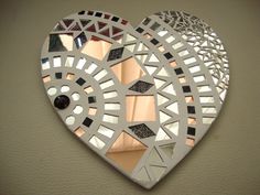 a heart shaped mirror hanging on the wall