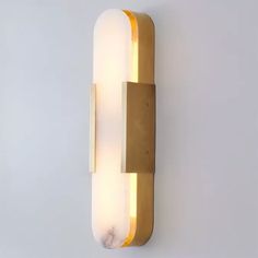 a light that is on the wall next to a white wall with a yellow strip