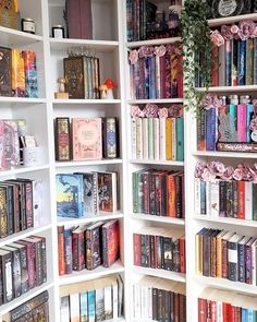 the bookshelves are filled with many different types of books and flowers on them