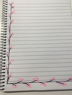 a spiral notebook with pink flowers on the page and lined paper attached to each side