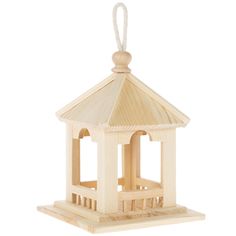 a wooden bird feeder with a white roof and a bell on the top, hanging from a string