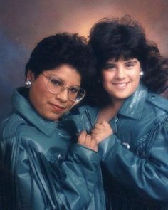 two women in leather jackets posing for a photo