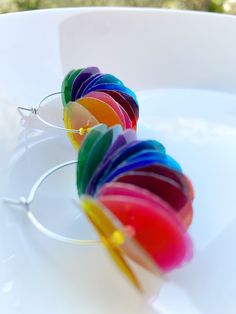 a pair of glasses with rainbow colored rims sitting on top of a white plate