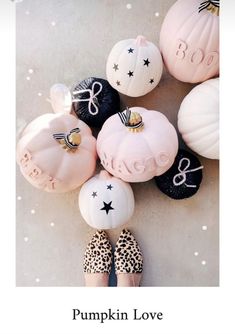 some pink and black pumpkins are sitting on the floor next to each other,