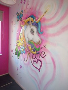 the wall is painted with an image of a unicorn's head and flowers on it