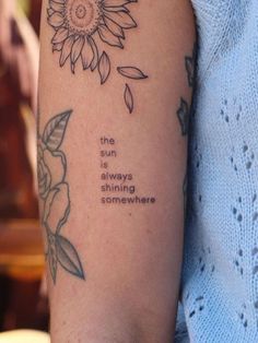 a woman's arm with a tattoo saying the sunflower is always coming somewhere