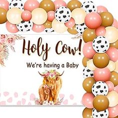 a cow is surrounded by balloons and other decorations for a baby's first birthday