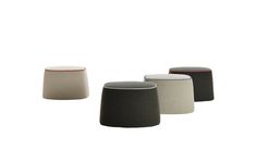 four different colored stools sitting next to each other