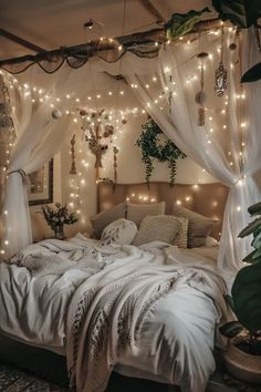 a bed with white sheets and lights hanging from the ceiling