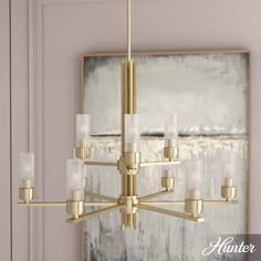 an elegant chandelier hangs from the ceiling in front of a painting and artwork