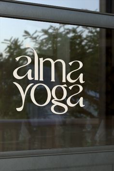 the words ama yoga written in white on a glass window