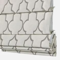 a white and grey patterned roman blind