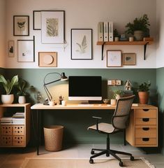 a home office with green walls and pictures on the wall