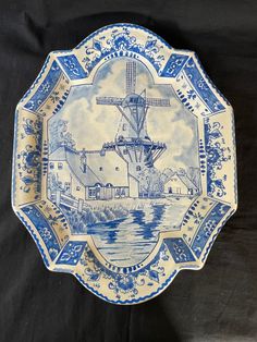 a blue and white plate with a windmill on it