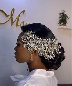 a woman wearing a bridal headpiece in front of a wall with the name mary written on it